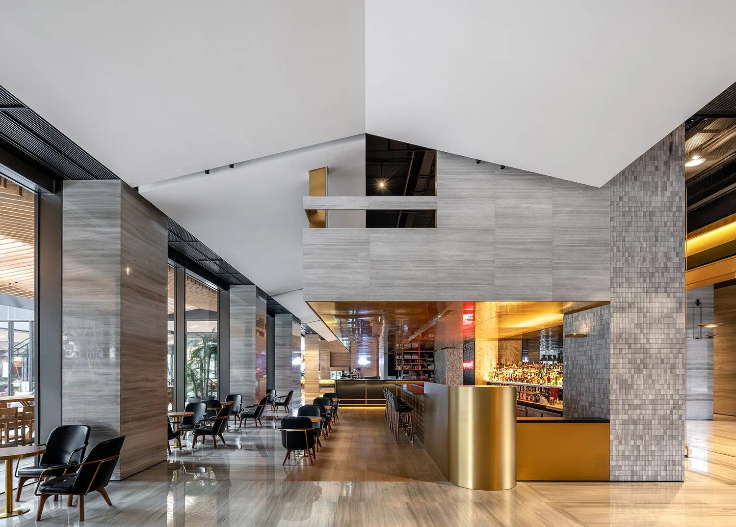 A modern restaurant bar with concrete walls and a bar counter.