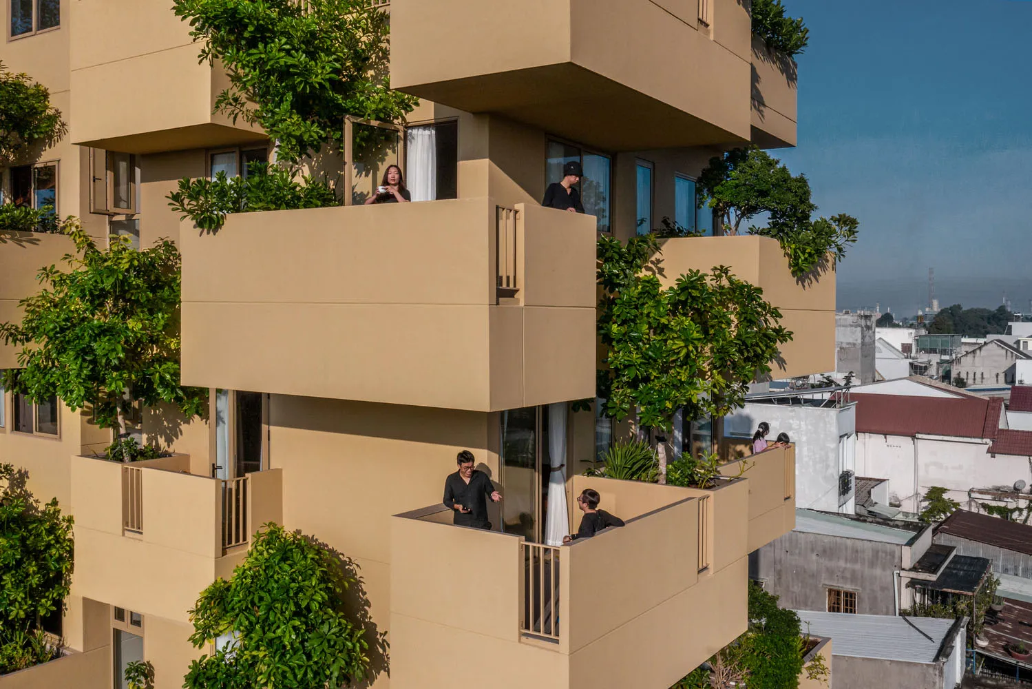 High-rise apartments featuring green vegetation and concrete structures.
