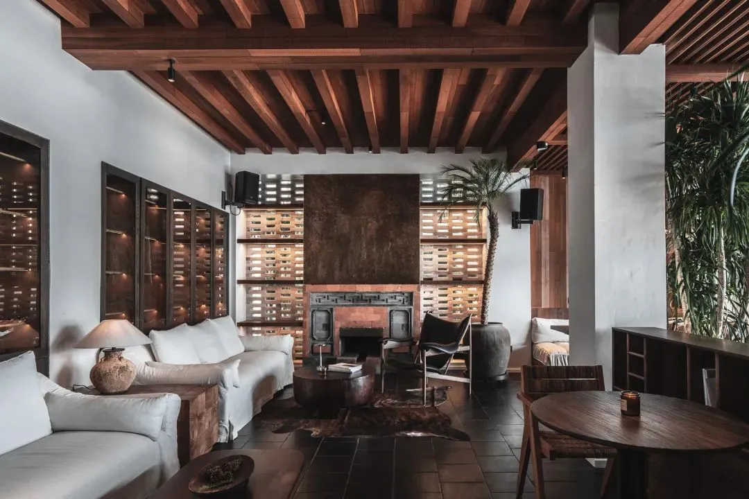 Industrial living room with wooden furniture and exposed beams.