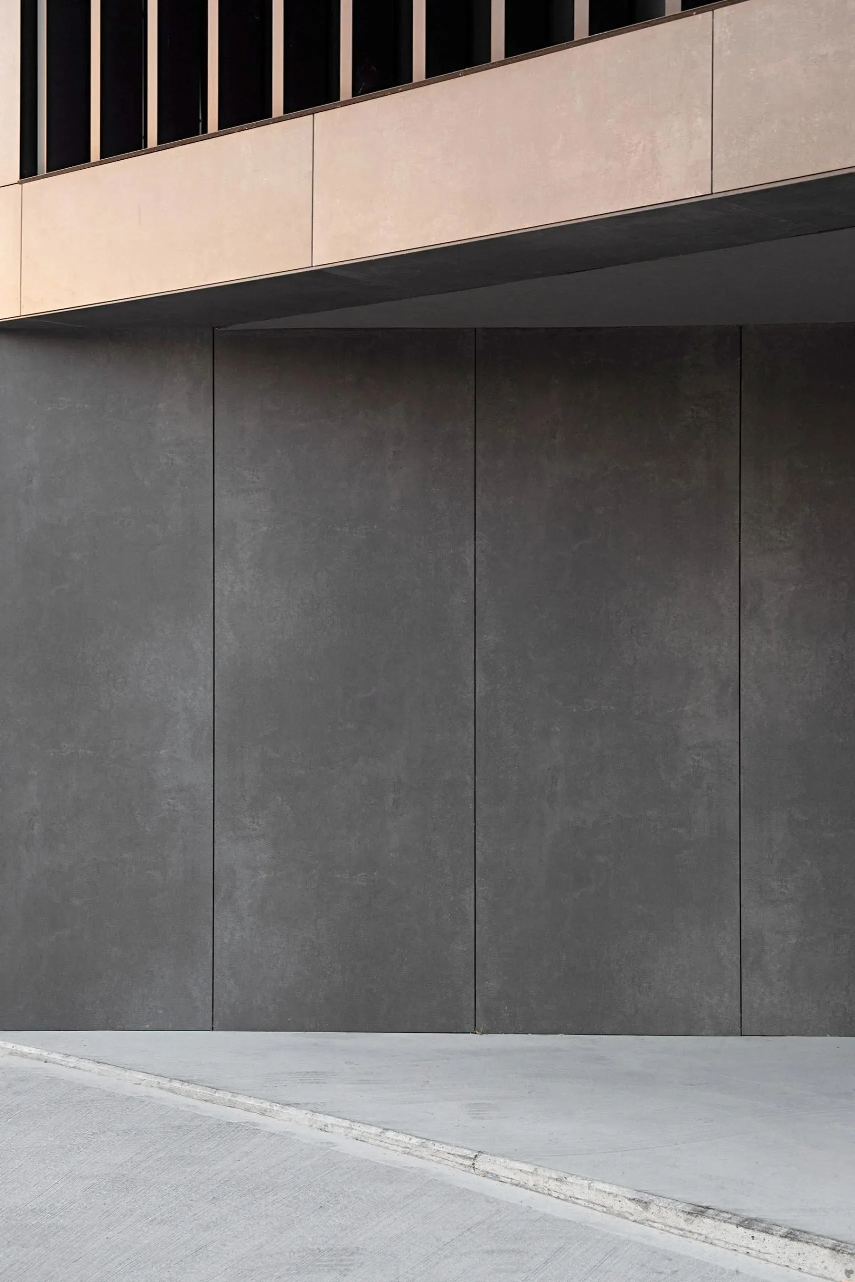 A minimalist, modern architectural exterior with clean concrete panels.