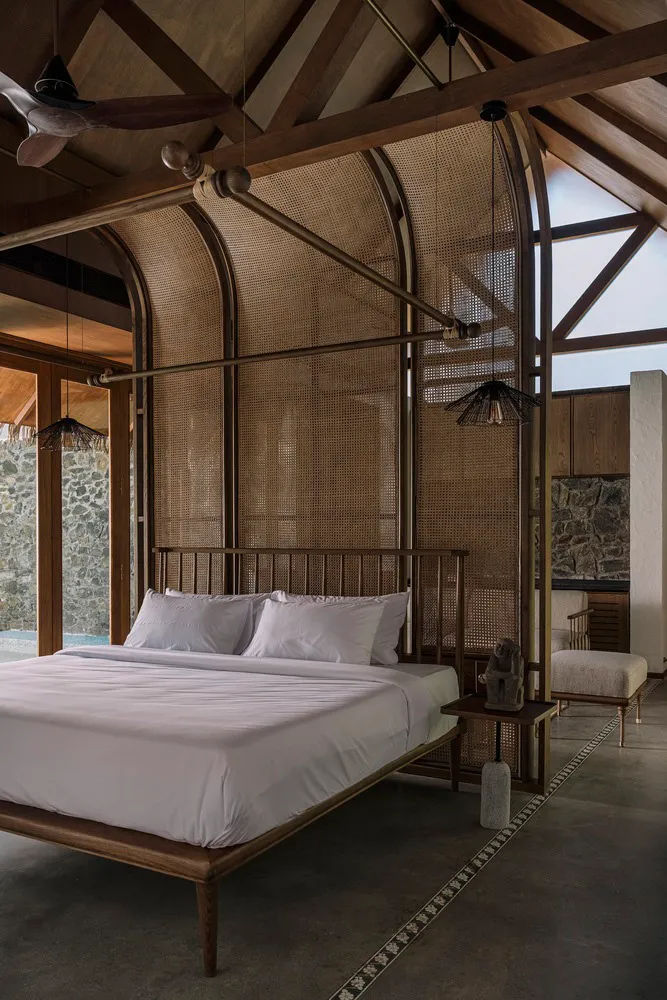A modern bedroom with a wooden bed frame and bamboo details.