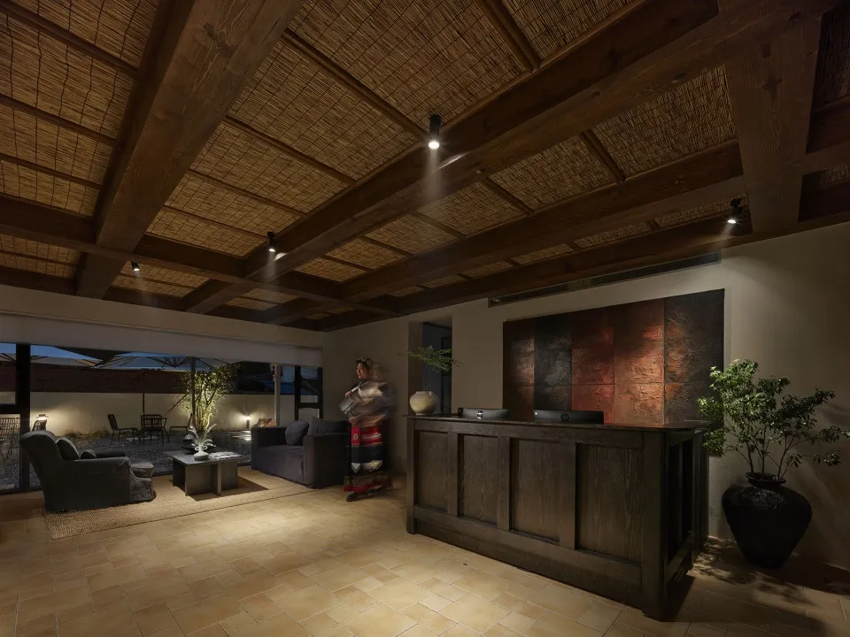 Modern lobby featuring a combination of textile and wooden materials, with a textured plaster ceiling.