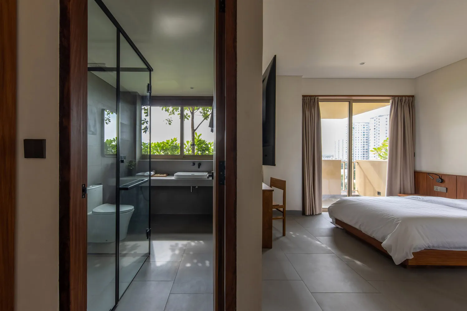 Modern minimalist bedroom featuring concrete and glass materials