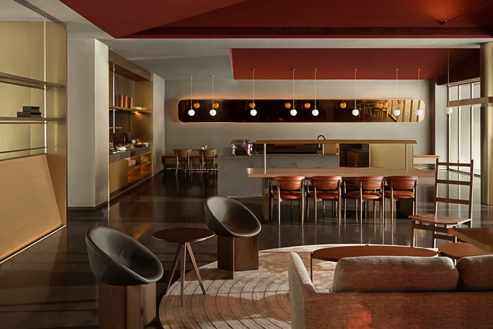 A modern residential living area featuring concrete walls and wooden furniture.