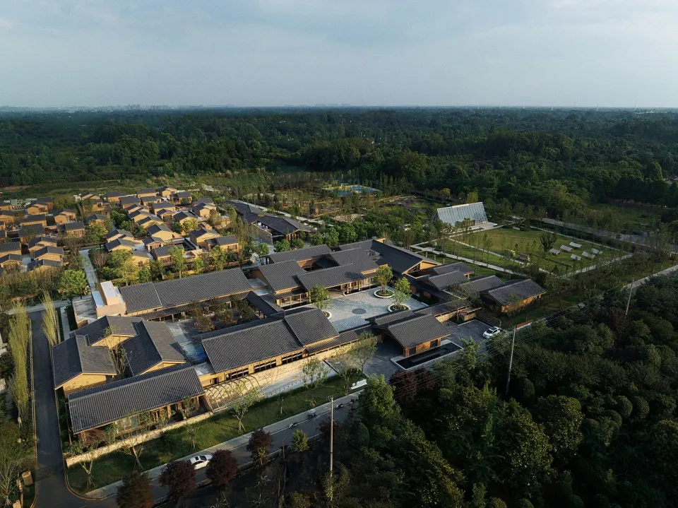 Aerial view of a modern residential complex surrounded by greenery.