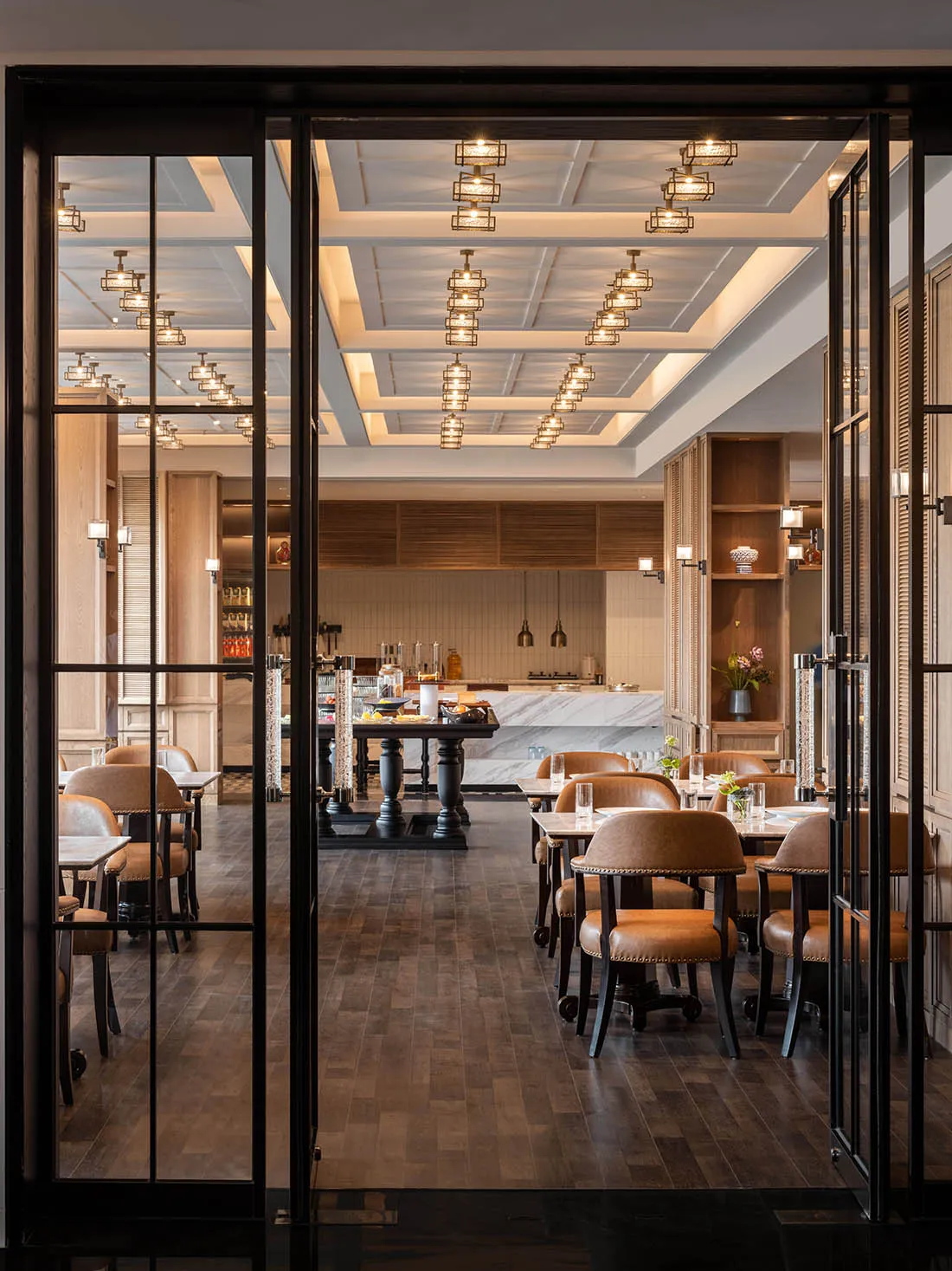 Industrial-style restaurant interior with marble countertops and wooden tables and chairs