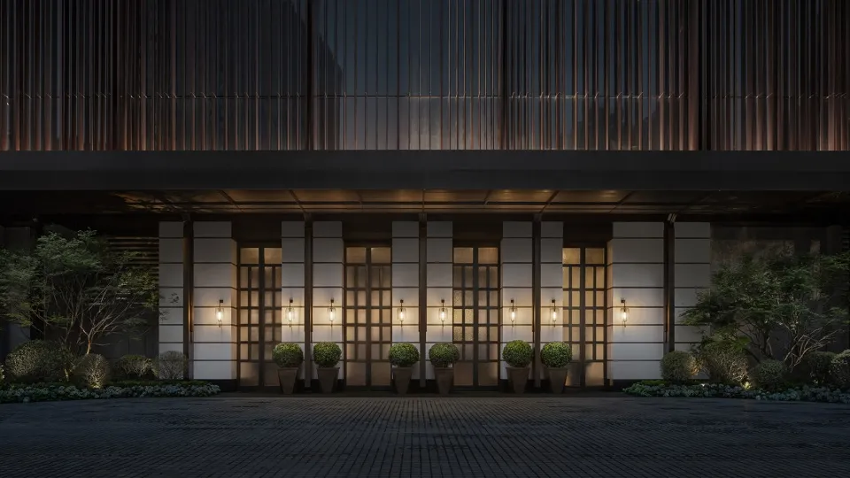 A modern office entrance featuring glass and concrete materials, with a welcoming atmosphere.