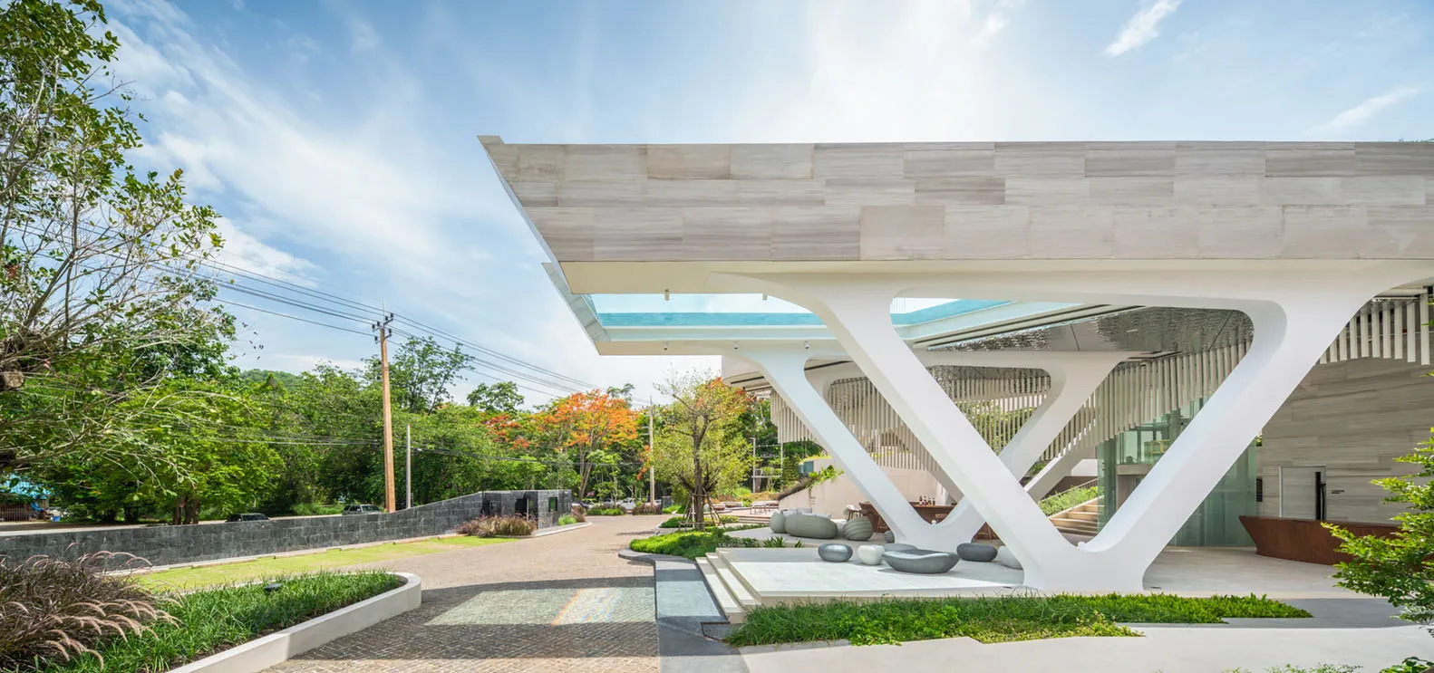 A modern building with a white marble exterior and a large sculptural entrance.