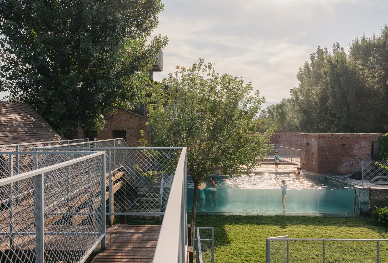 Poolside area with concrete, brick, and metal structures