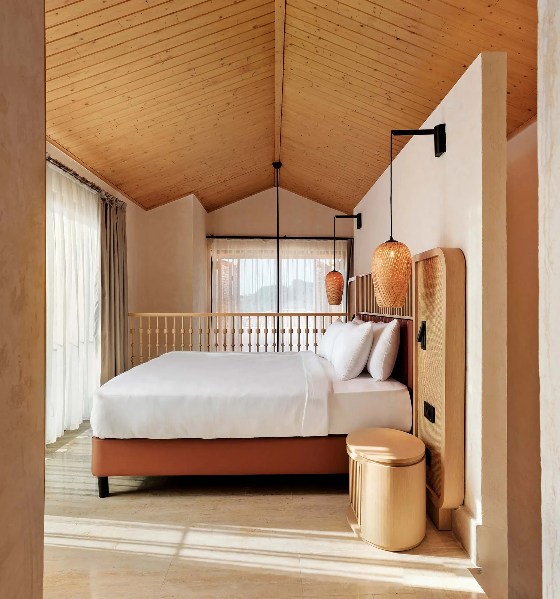 Modern bedroom with brown furniture, white sheets, and rattan pendant lights.