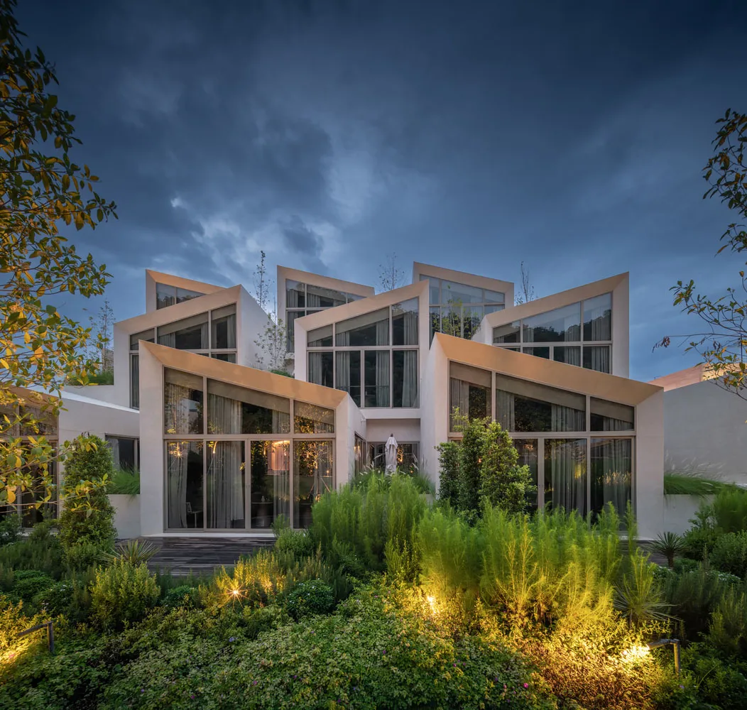 Modern residential building with concrete and glass exterior and interior design.
