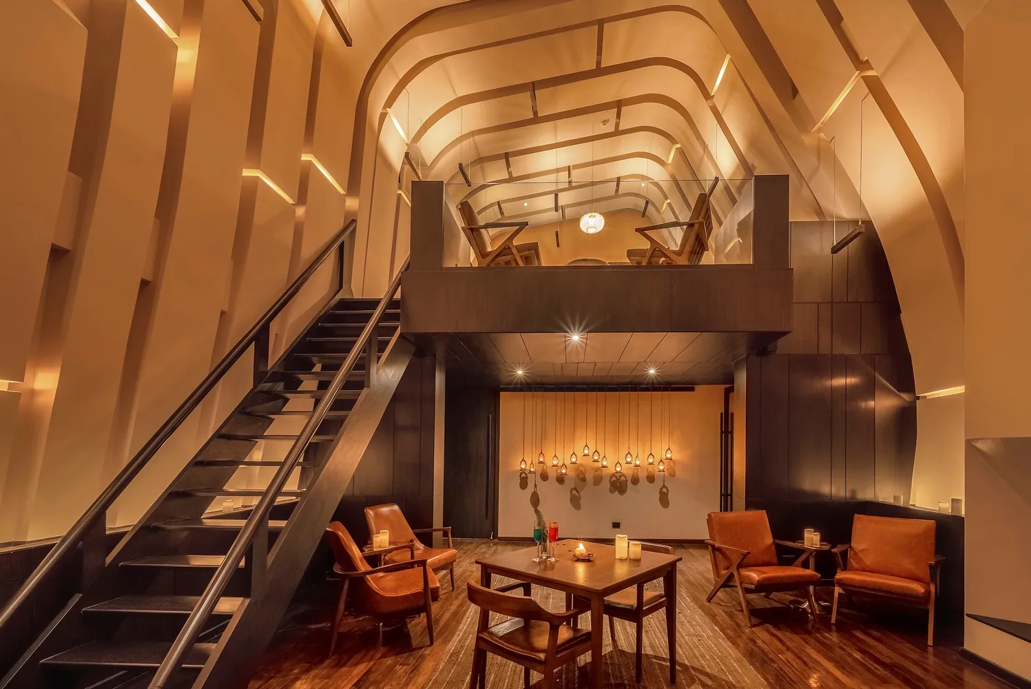 Industrial-style restaurant interior with wooden furniture and exposed ceiling beams.
