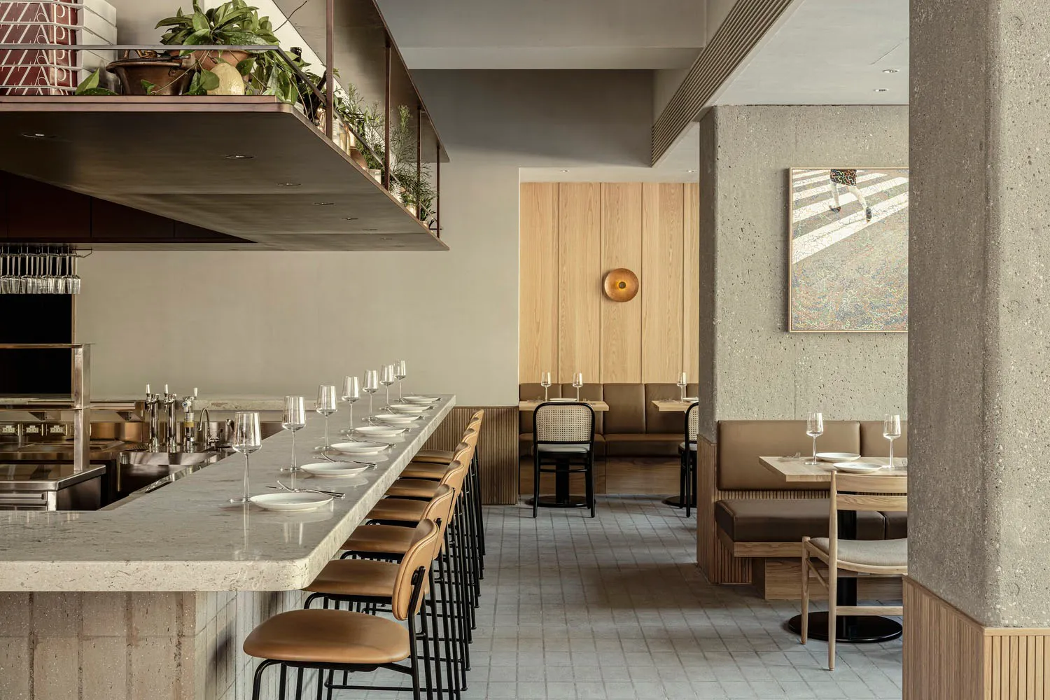 A modern restaurant interior with concrete walls and wooden seating