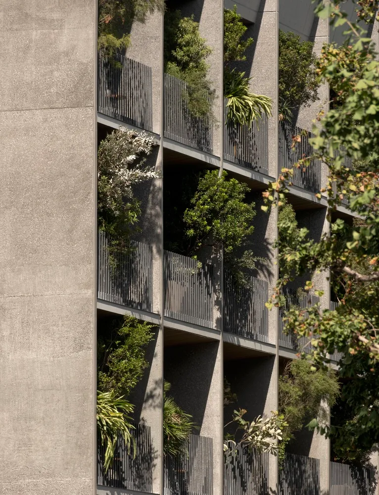 Concrete building with greenery on balconies
