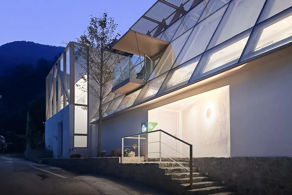Modern building with large glass windows at dusk