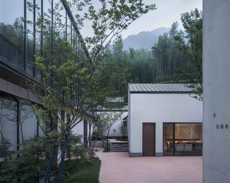 Modern residential space with glass walls and concrete finishes