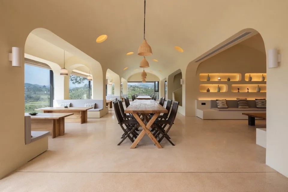 Contemporary cafe interior with wooden furniture and comfortable seating areas.