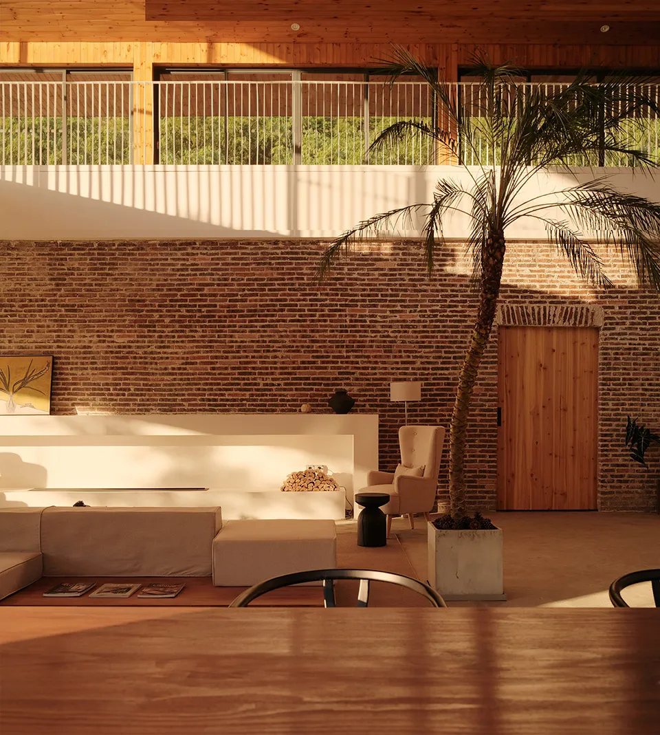 A modern living room with exposed brick walls, wooden furniture, and a potted palm plant.