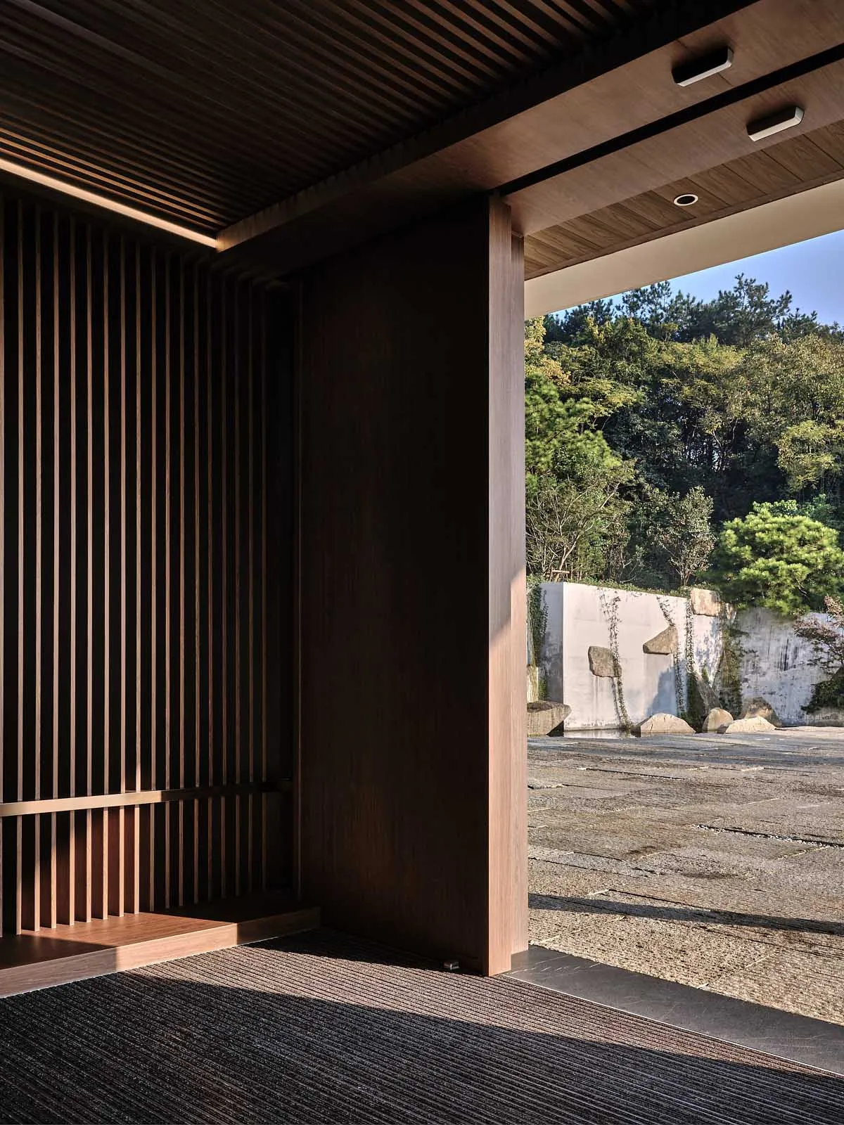 A modern residential interior featuring wood elements and natural light.