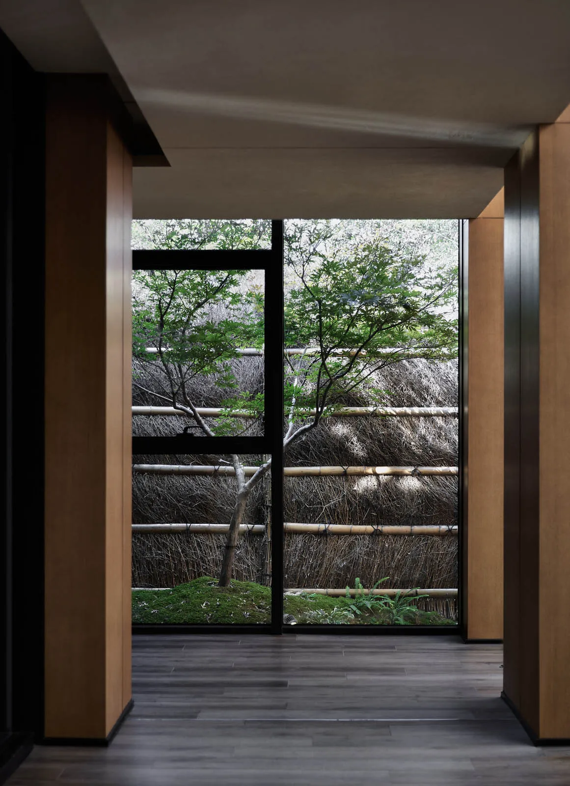 A view through a wooden window in an industrial-style room.