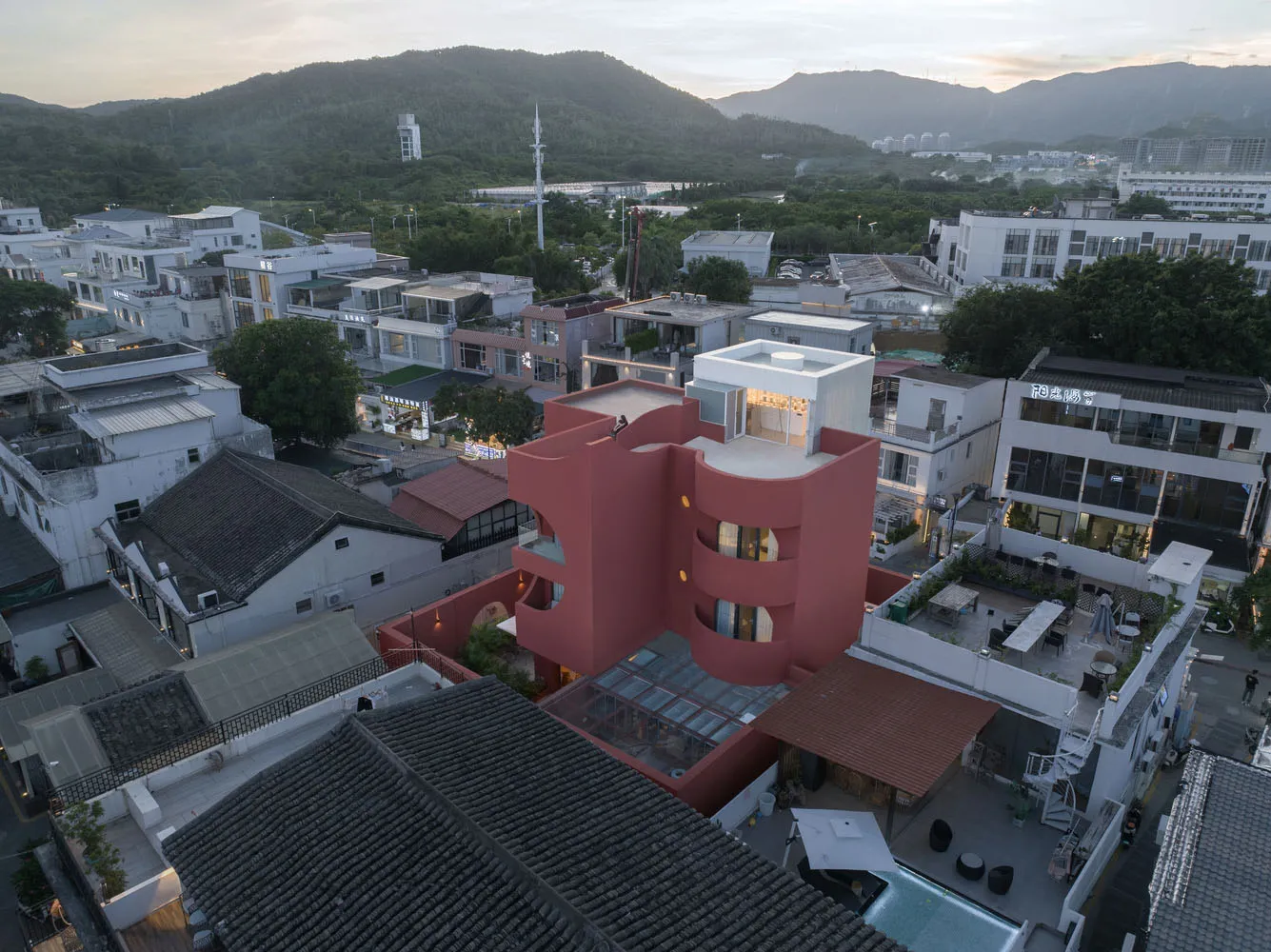 Modern architecture featuring red exterior concrete building with unique design.
