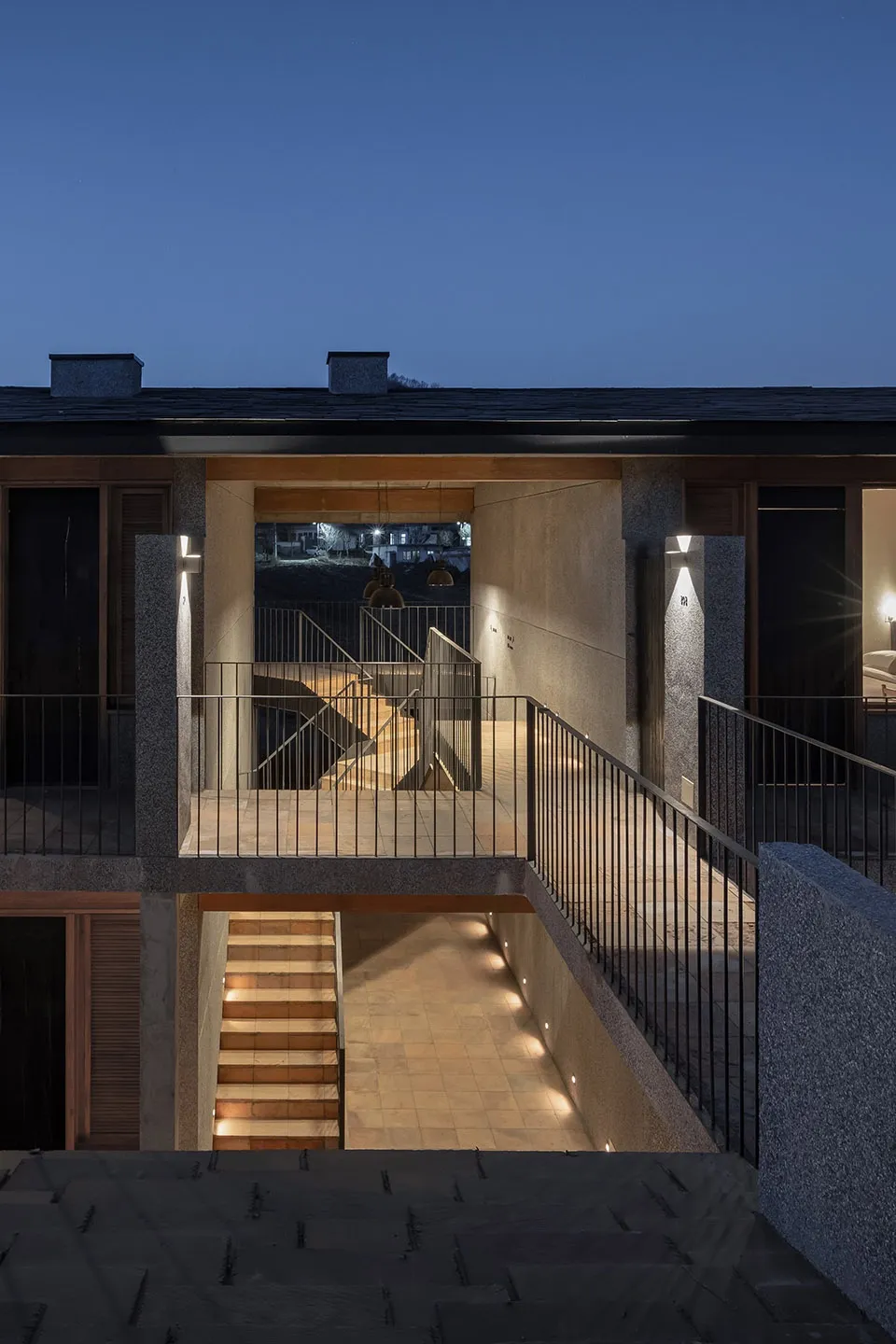Concrete and metal staircase with ambient lighting in an indoor setting.