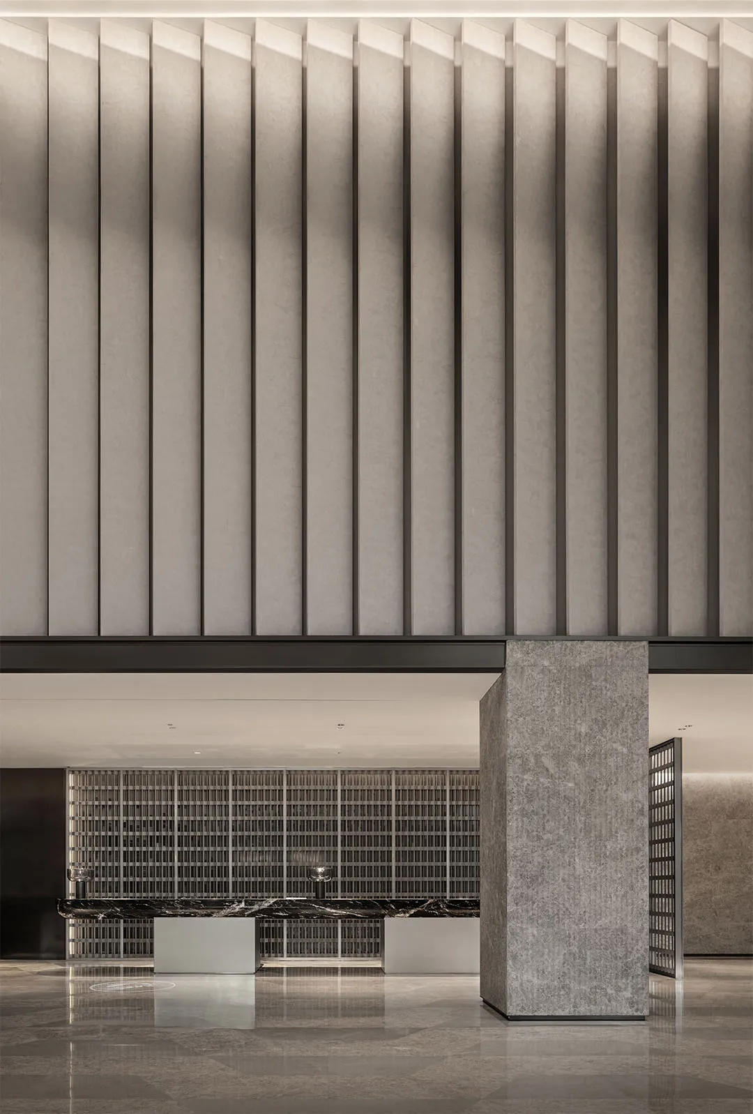 A modern lobby interior with concrete walls and a minimalist design.