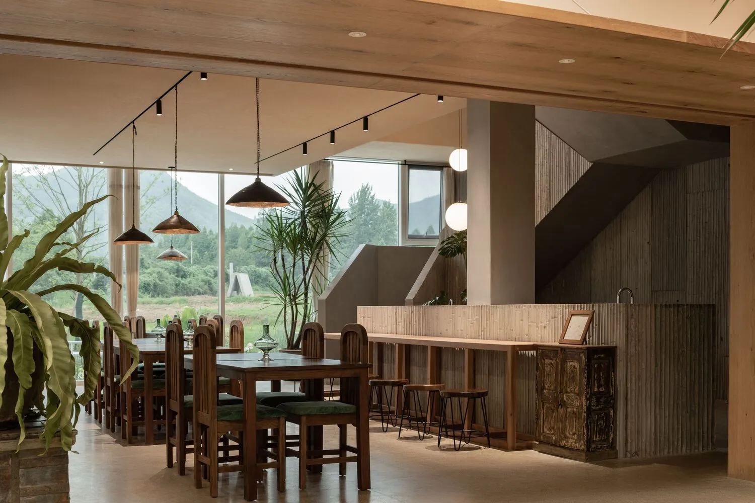 A modern restaurant interior featuring natural lighting and wooden elements.