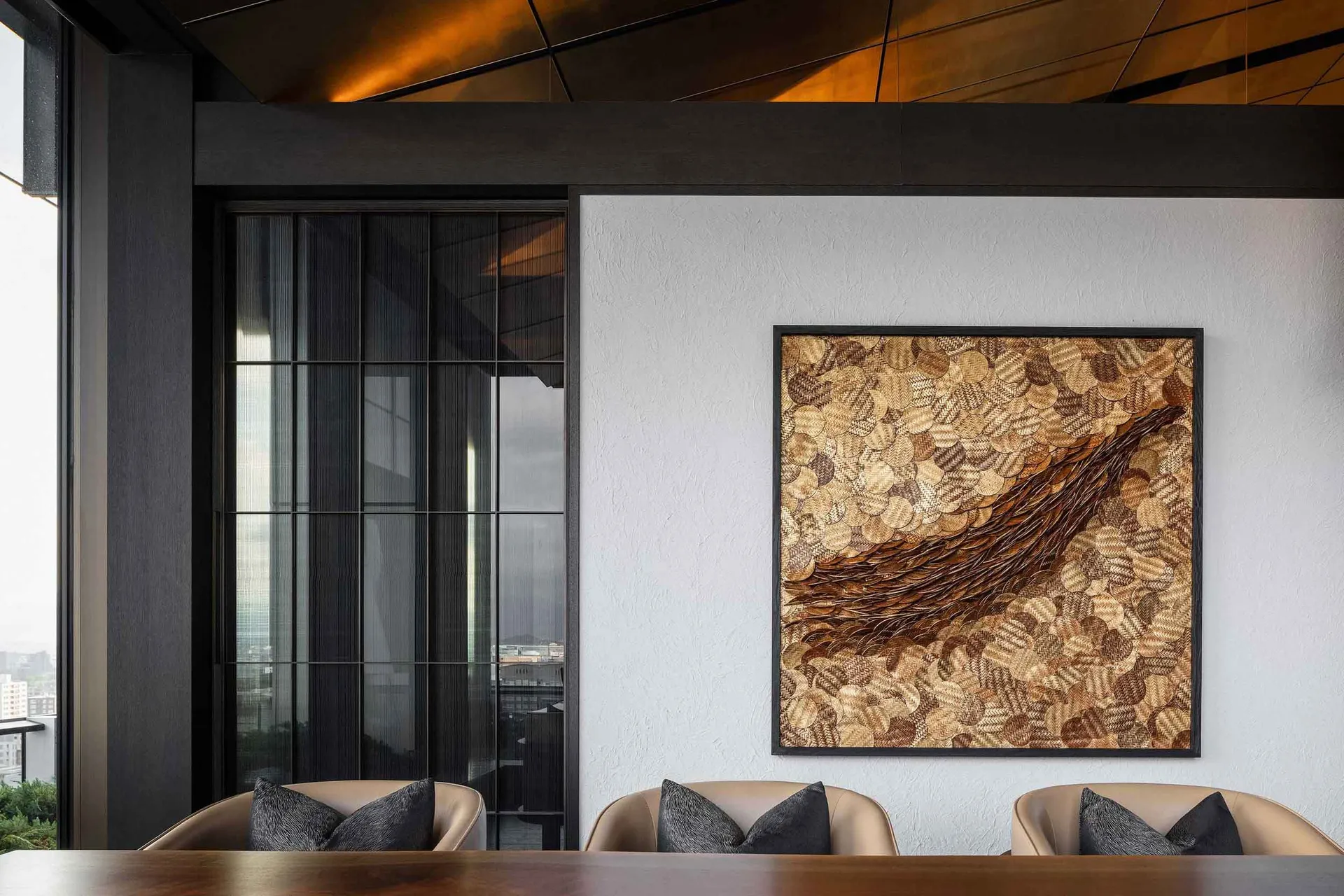 A modern dining room featuring a textured wood accent wall and black-framed sliding glass doors overlooking an outdoor terrac