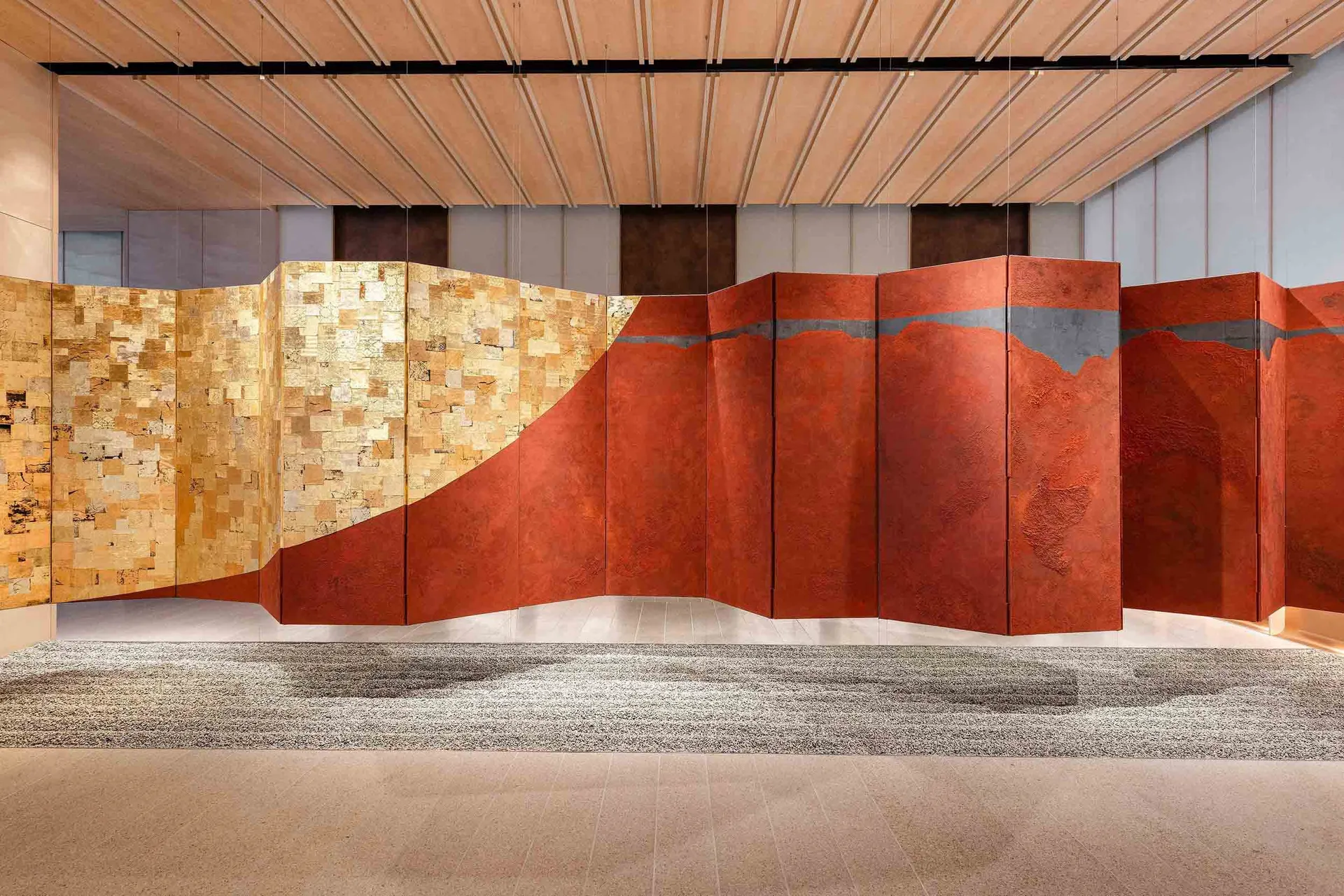 A modern corporate office space decorated with metallic textured paneling.