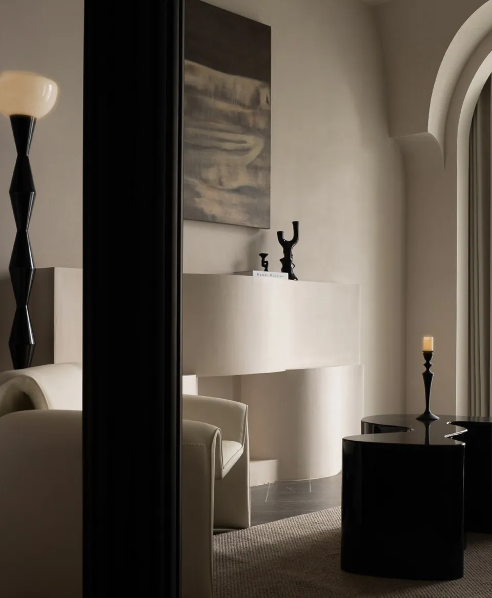 A modern minimalist living room with neutral tones, elegant furniture, and decorative elements.