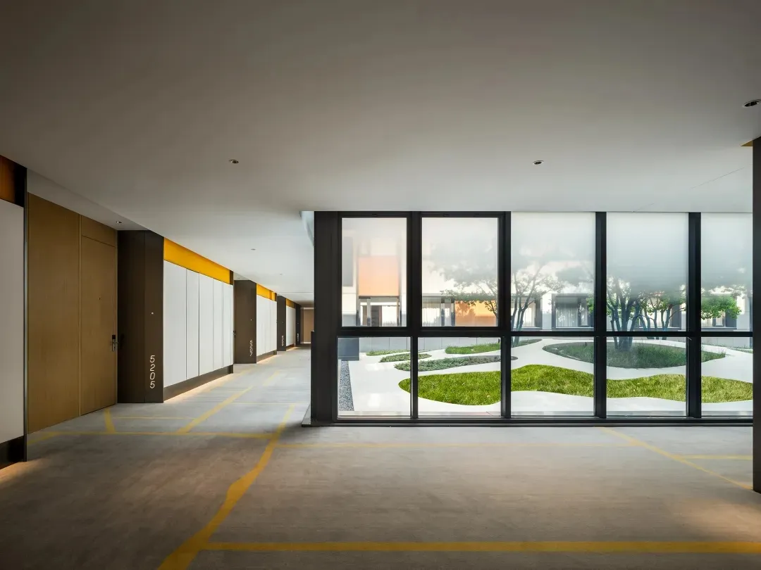 An image of a modern minimalist residential interior with a concrete floor.