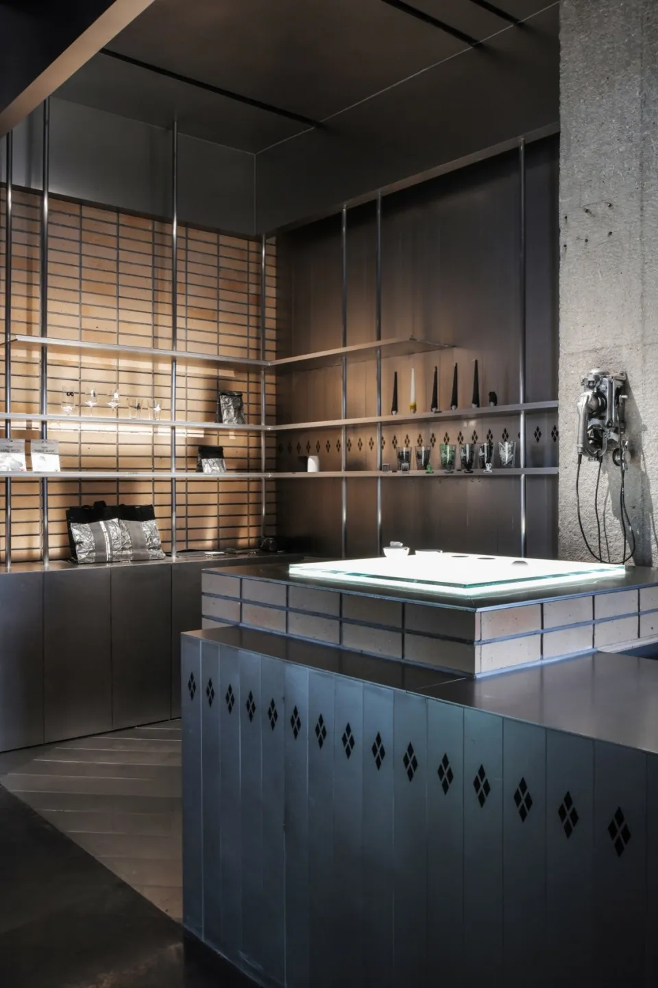 A minimalist storefront with a metal exterior and large windows.