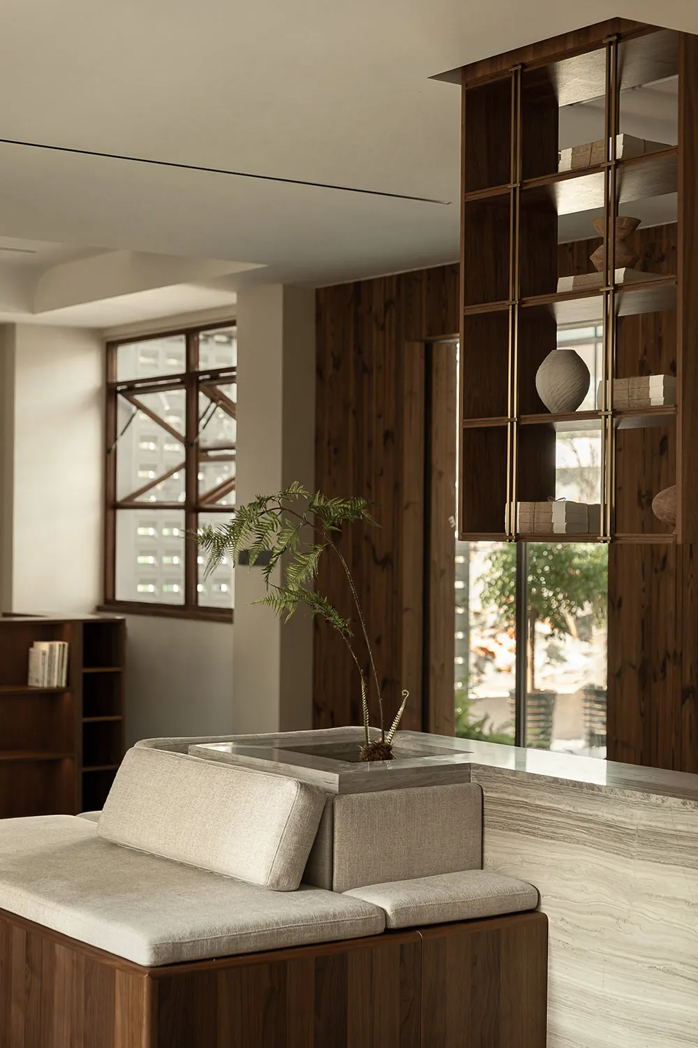 A minimalist residential interior featuring wood and marble elements.