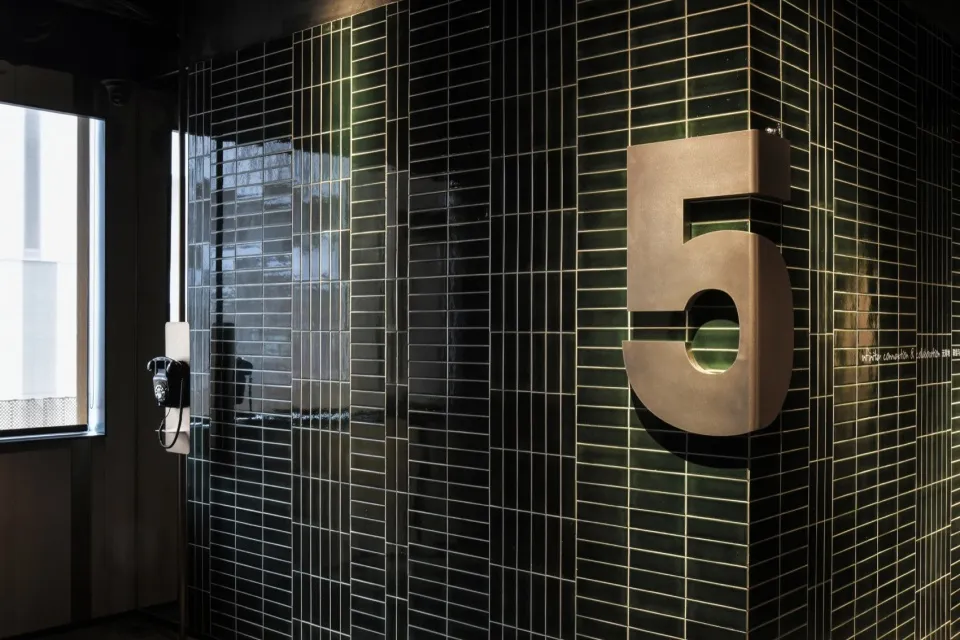 Modern building with black tiles featuring number 5.