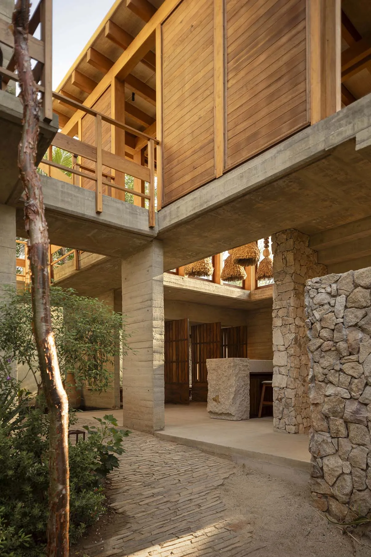 Modern residential space featuring stone, concrete, and wood materials.