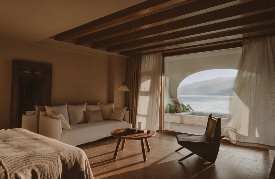 A minimalist bedroom featuring curtains and wooden furniture.