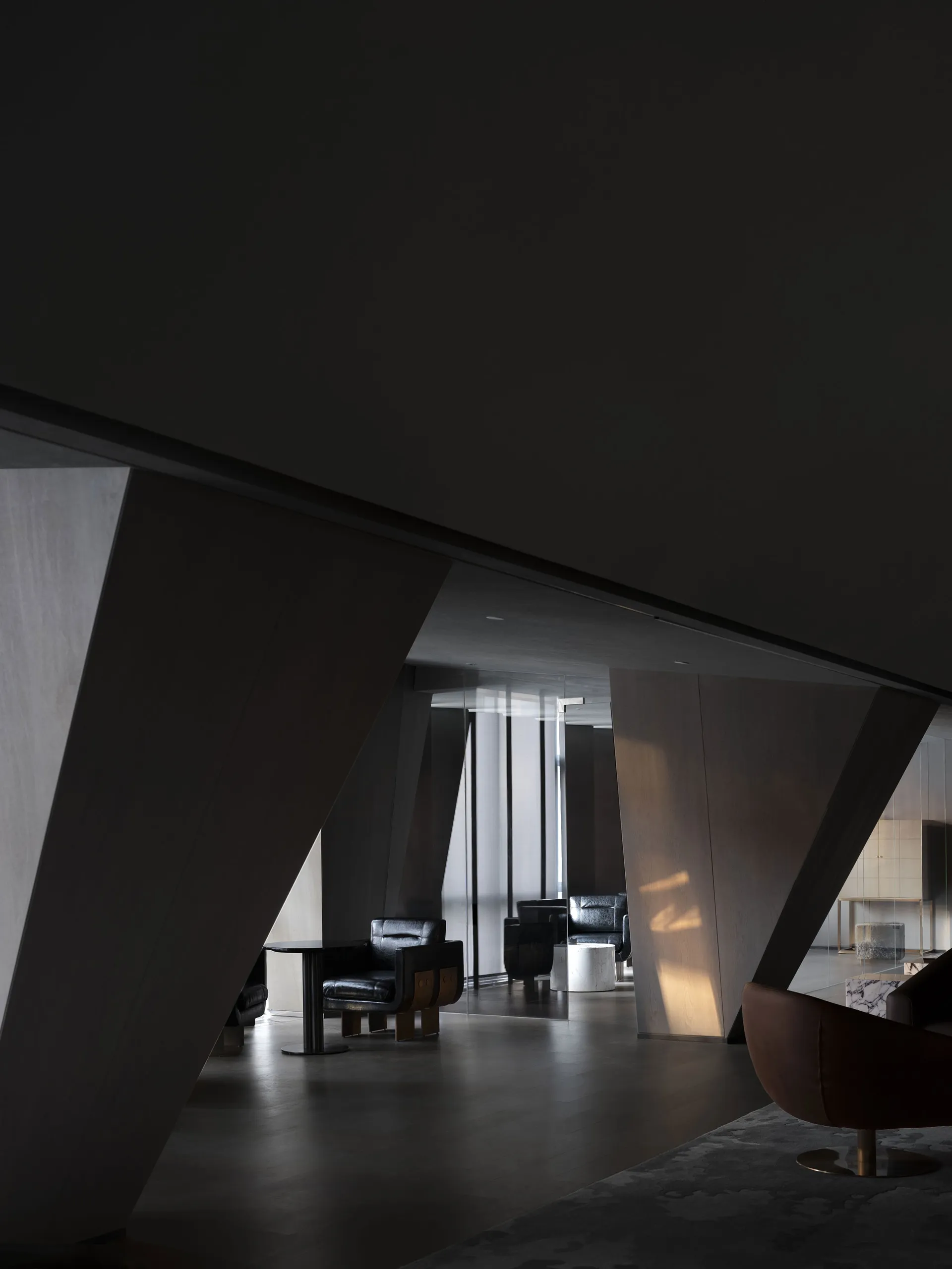 A modern lobby with dark wood finishes and minimalist design elements.