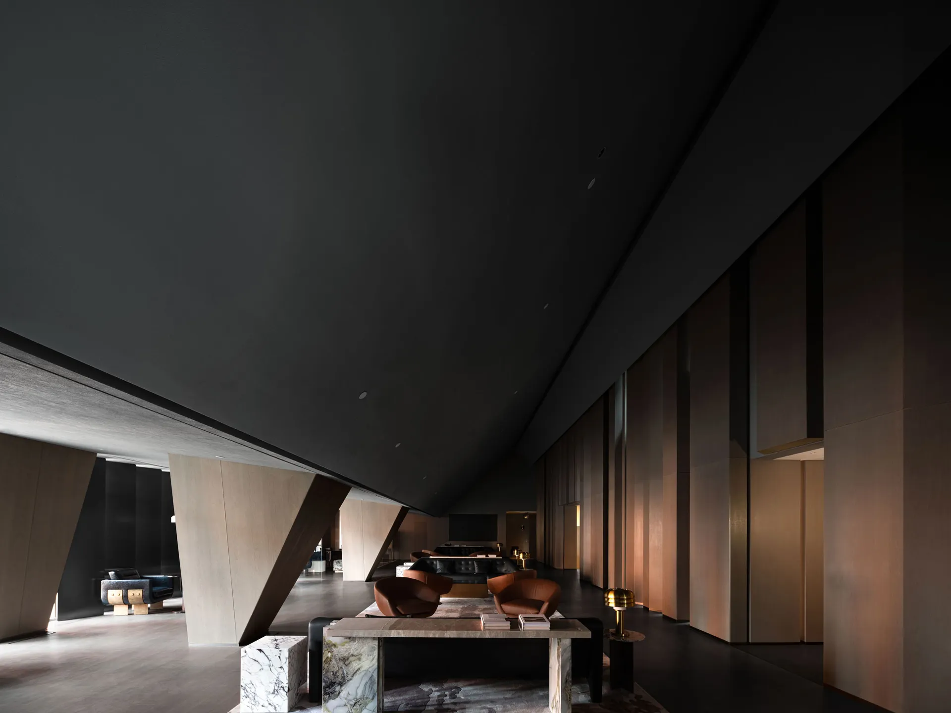 A modern minimalist lobby featuring marble and wood materials.