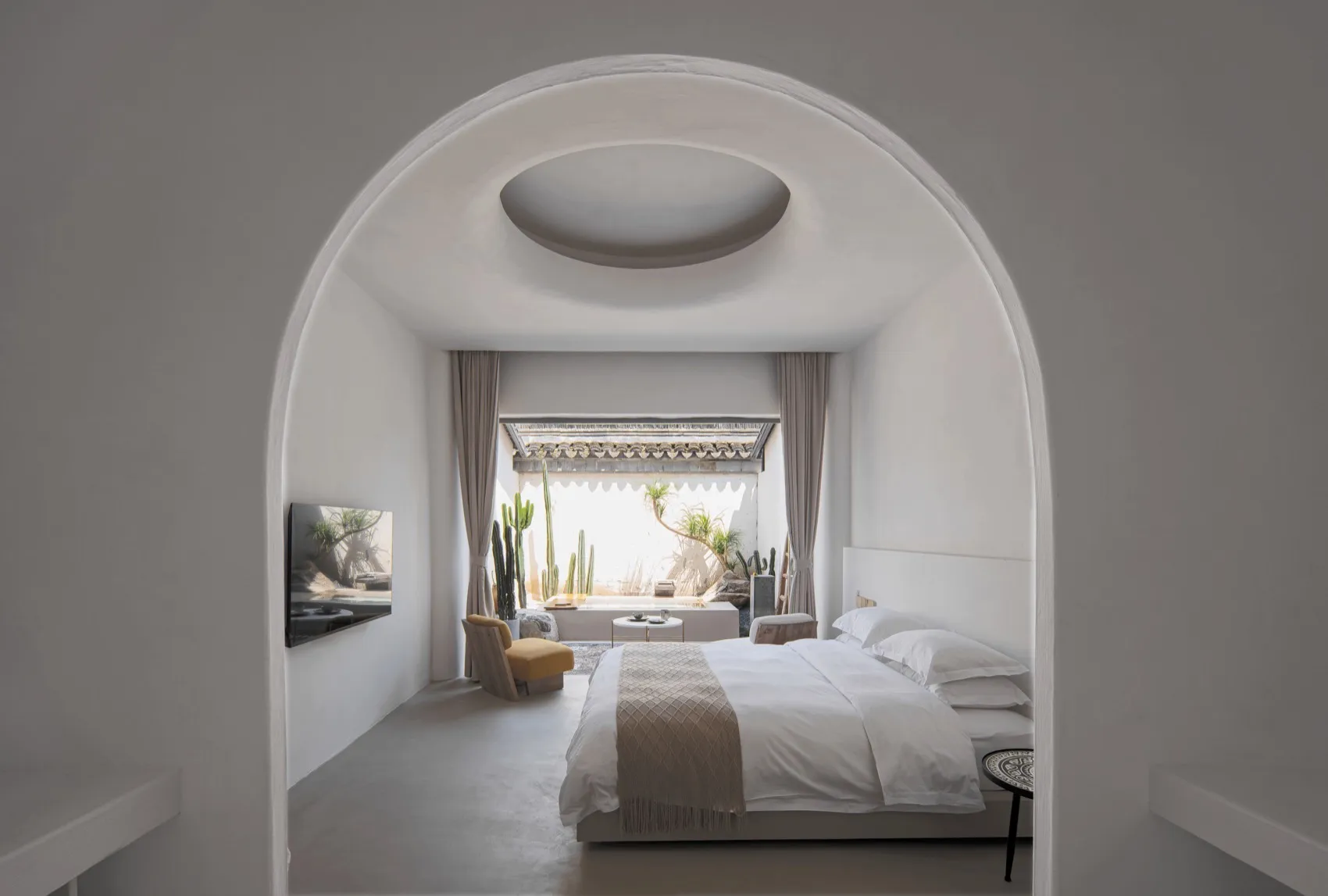 Modern minimalist bedroom featuring a textured concrete floor and wall.
