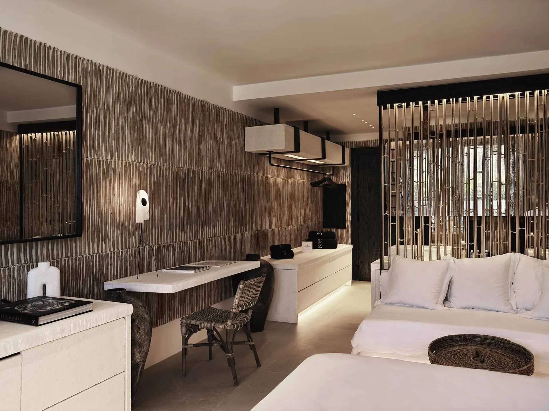 Modern bedroom with minimalist design, featuring a white bed, desk, and abstract wall textures.