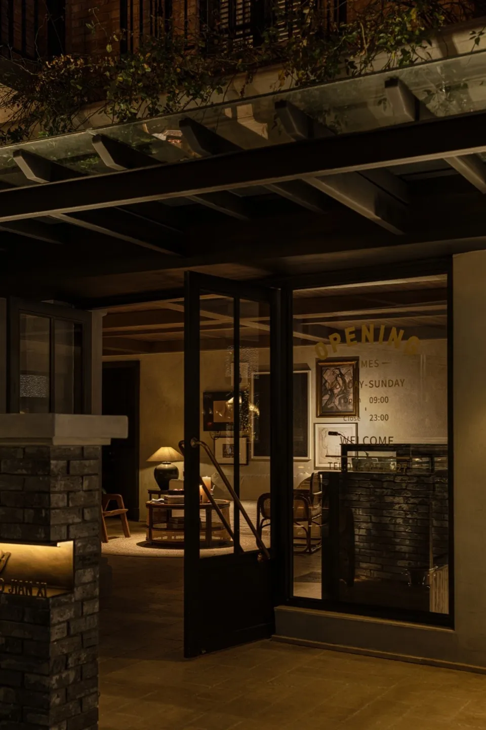 A nighttime view of an industrial lobby featuring brick and concrete materials.