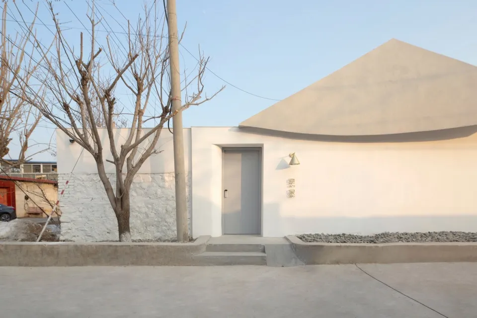 A minimalist entryway featuring a concrete door and wall with a sleek, modern design.
