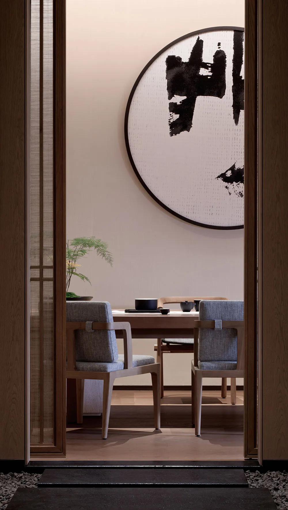 Minimalist dining room featuring wooden furniture and fabric seating
