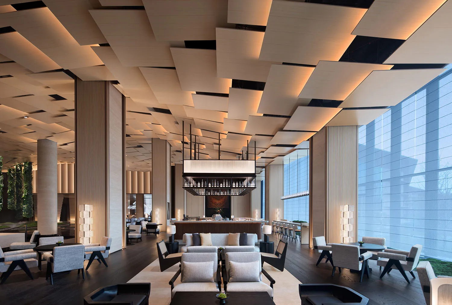 A modern lobby featuring wooden panels, glass windows, and metallic fixtures.