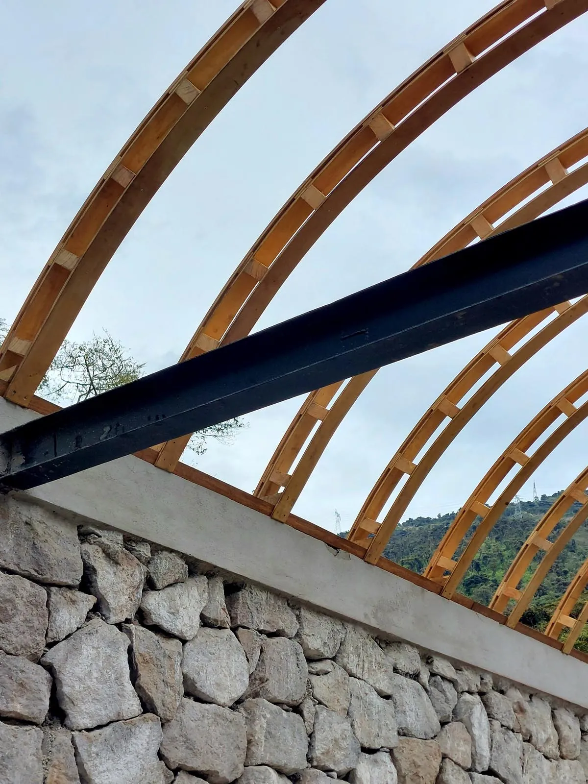 Wooden and metal roof trusses supporting a structure.