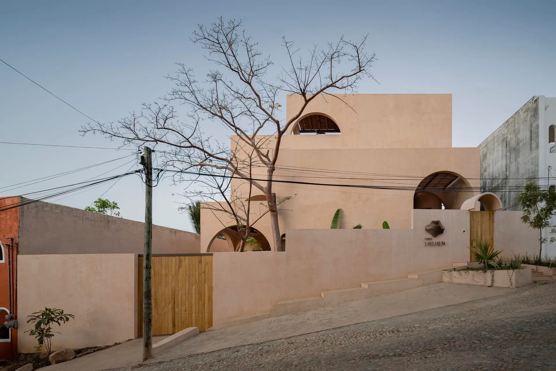 Modern architectural building with sandstone exterior and arches