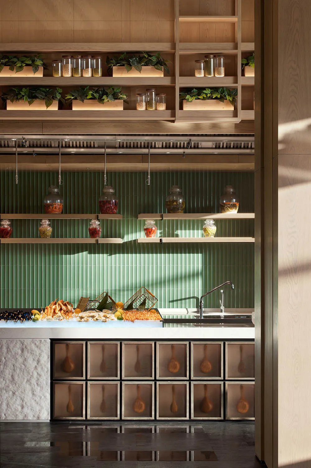 A well-organized kitchen interior featuring wooden shelves stocked with various ingredients and plants.