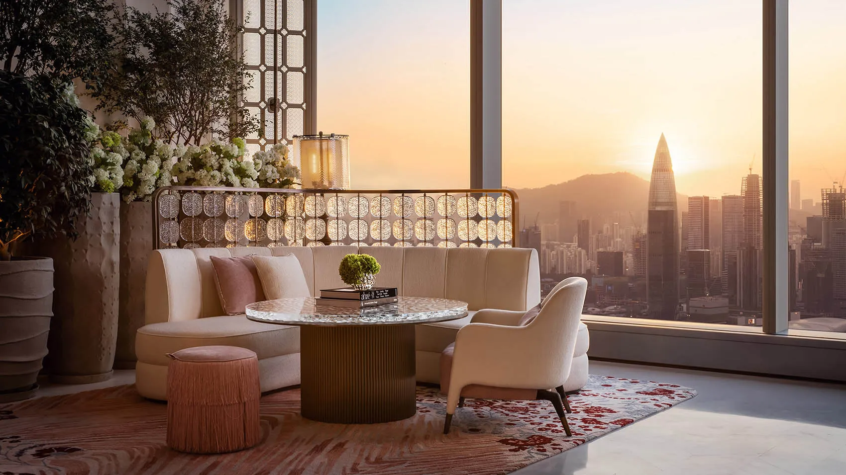 A modern living room with a city view at sunset.