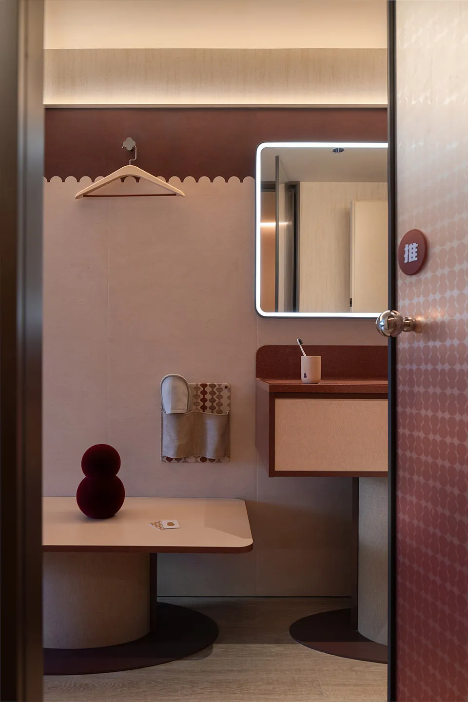 A minimalist bathroom featuring a terrazzo countertop, fabric accents, and wooden elements.